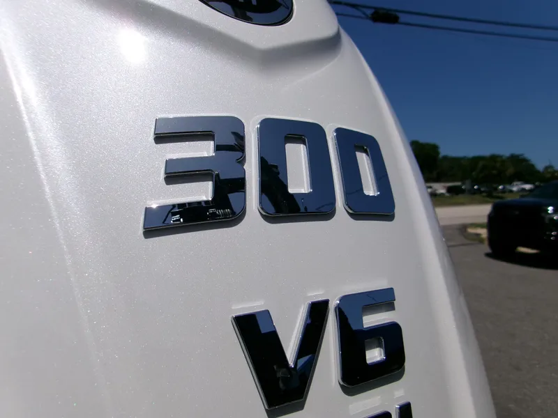 Slide: The Image of Close-up of 2025 Sportsman Masters 247OE Bay Boat engine, featuring 300 V6 emblem. - 5