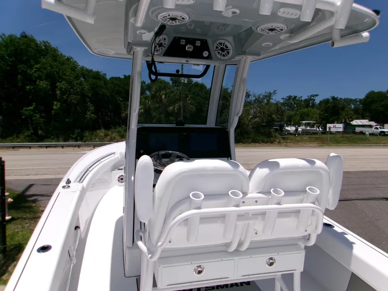 Slide: The Image of 2025 Sportsman Masters 247OE Bay Boat interior with dual seats and console, parked outdoors. - 7