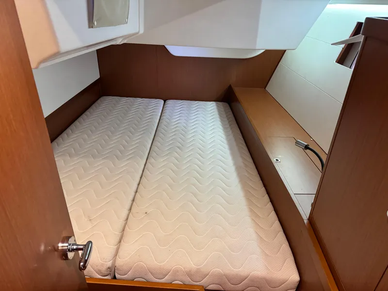 Slide: The Image of 2014 Beneteau Oceanis 48 cabin interior with twin mattresses and wooden finish. - 30