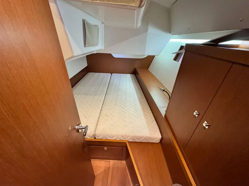 Slide: The Image of 2014 Beneteau Oceanis 48 cabin interior with wooden finish and comfortable bedding. - 32