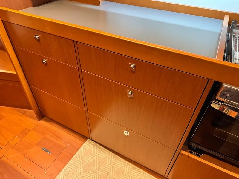 Slide: The Image of Wooden cabinetry in 2014 Beneteau Oceanis 48 yacht interior, featuring sleek drawers and modern design. - 35