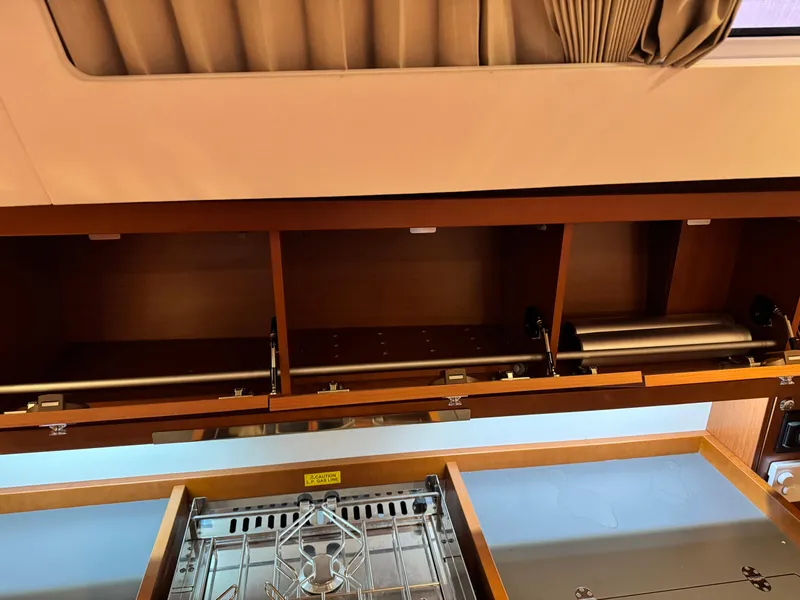 Slide: The Image of Interior view of 2014 Beneteau Oceanis 48 yacht kitchen with open cabinets and stove. - 39