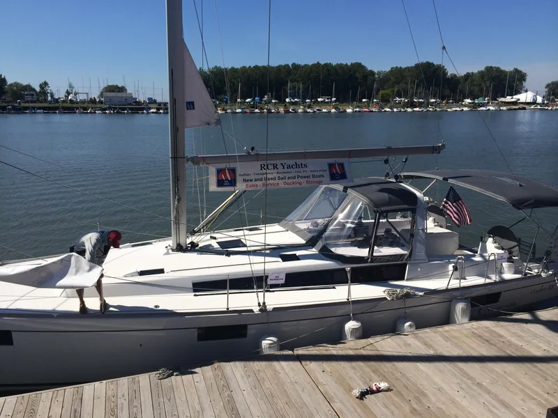 Slide: The Image of 2014 Beneteau Oceanis 48 yacht docked at marina with American flag. - 4