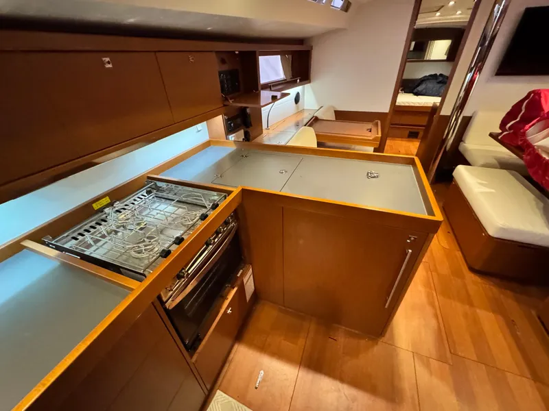 Slide: The Image of Interior of 2014 Beneteau Oceanis 48 yacht, featuring a modern kitchen and seating area. - 40