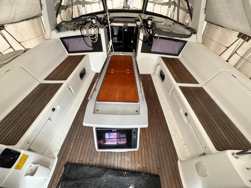 Slide: The Image of 2014 Beneteau Oceanis 48 yacht cockpit with teak flooring and spacious seating. - 6