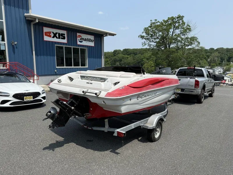 Slide: The Image of 2013 Crownline 185 SS boat on trailer outside dealership. - 1