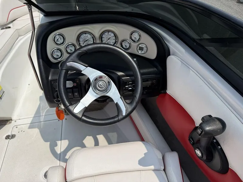 Slide: The Image of 2013 Crownline 185 SS boat dashboard with steering wheel and gauges. - 10