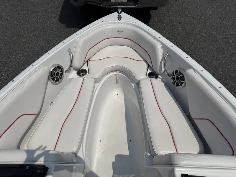 Slide: The Image of 2013 Crownline 185 SS boat interior with white seating and red trim. - 11