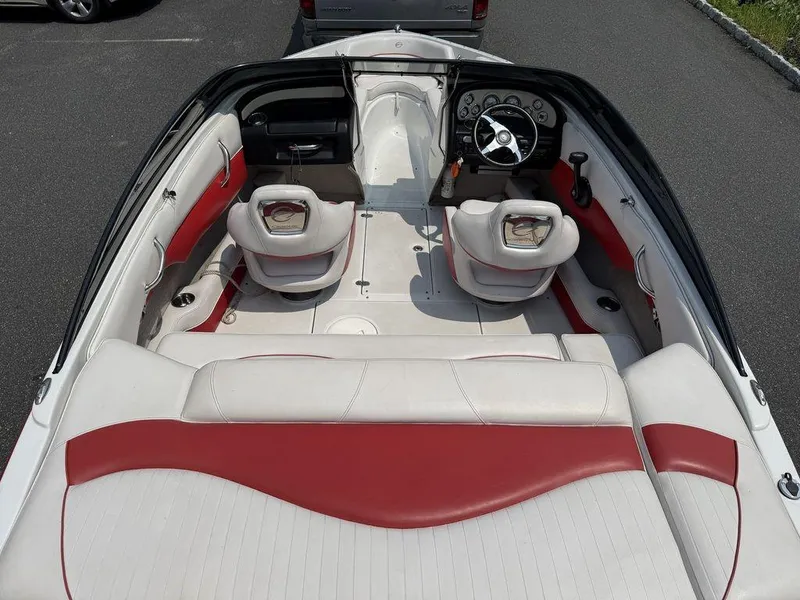 Slide: The Image of 2013 Crownline 185 SS boat interior with red and white seating, steering wheel, and dashboard. - 12