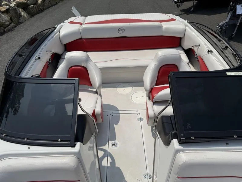 Slide: The Image of 2013 Crownline 185 SS boat interior with red and white seating, open windshield. - 7