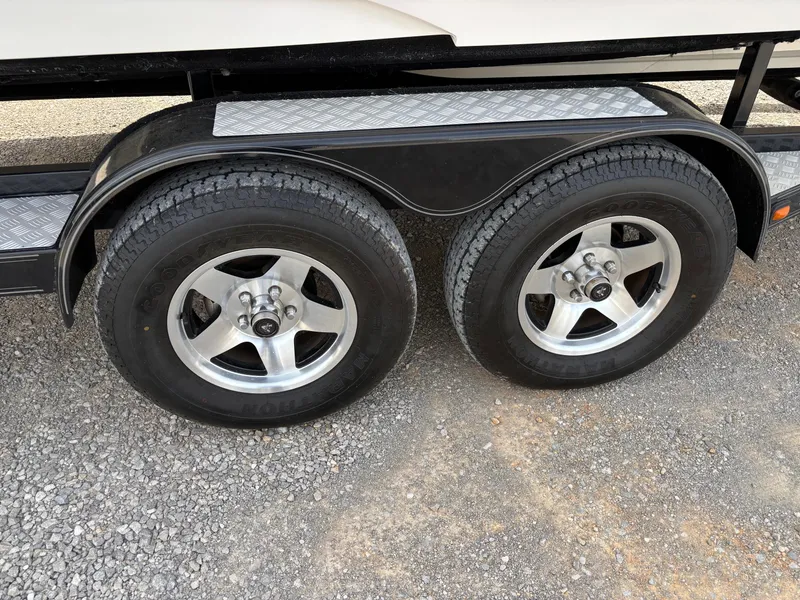 Slide: The Image of Dual axle trailer wheels on a 2009 Bryant 268 boat trailer. - 18