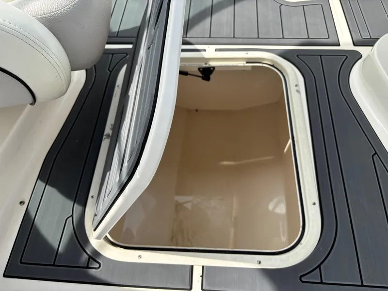 Slide: The Image of Open storage compartment on a 2009 Bryant 268 boat deck. - 8
