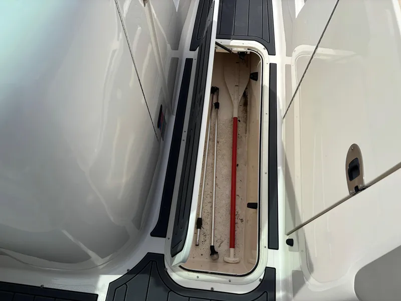 Slide: The Image of Storage compartment on a 2009 Bryant 268 boat, featuring sleek white and black design. - 9