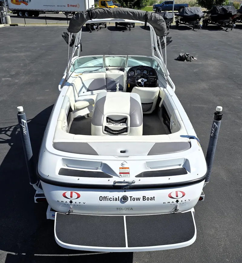 Slide: The Image of 2000 Toyota Epic 22 boat, white, official tow boat, rear view, parked on asphalt. - 12