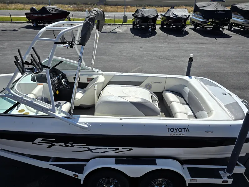 Slide: The Image of 2000 Toyota Epic 22 boat with white interior and sleek design on a trailer. - 14