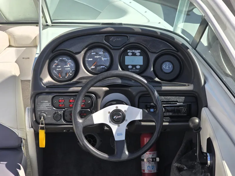 Slide: The Image of Dashboard of a 2000 Toyota Epic 22 boat with steering wheel and gauges. - 16