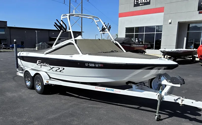 Slide: The Image of 2000 Toyota Epic 22 boat on trailer, parked outside a dealership. - 2