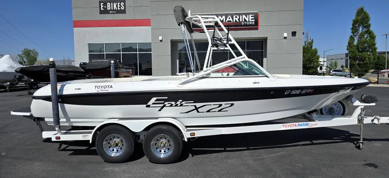 Slide: The Image of 2000 Toyota Epic 22 boat on trailer outside a marine store. - 8