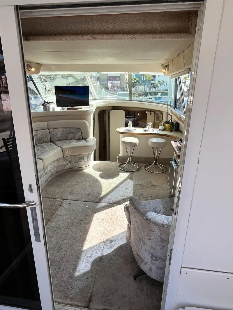 Slide: The Image of Interior of a 1996 Sea Ray 370 Sedan Bridge yacht with seating and a small table. - 14
