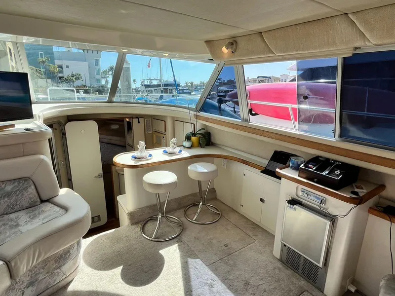 Slide: The Image of Interior of 1996 Sea Ray 370 Sedan Bridge yacht with seating and kitchenette. - 17