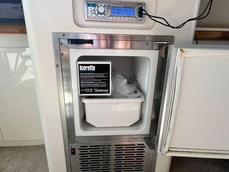 Slide: The Image of Ice maker on 1996 Sea Ray 370 Sedan Bridge yacht, featuring a compact design and stainless steel finish. - 20