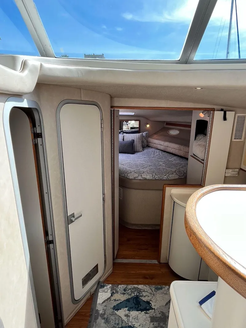 Slide: The Image of Interior of 1996 Sea Ray 370 Sedan Bridge, featuring cozy cabin and modern design. - 24