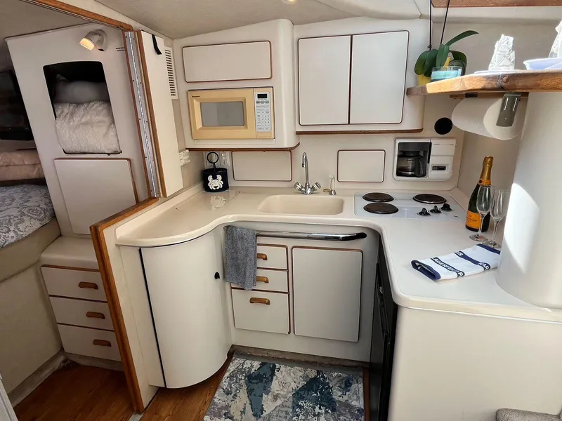 Slide: The Image of 1996 Sea Ray 370 Sedan Bridge yacht kitchen with modern amenities and cozy design. - 26