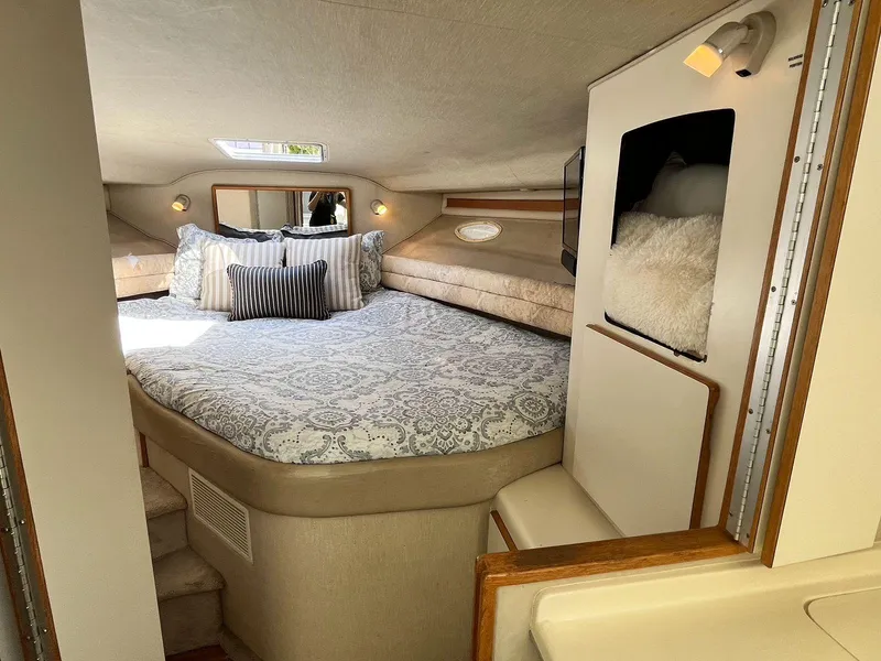 Slide: The Image of Interior of 1996 Sea Ray 370 Sedan Bridge with cozy bed and elegant decor. - 27