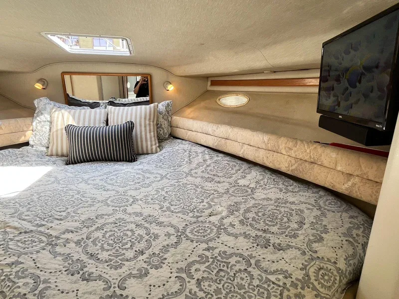 Slide: The Image of Cozy interior of 1996 Sea Ray 370 Sedan Bridge with bed, pillows, and TV. - 29
