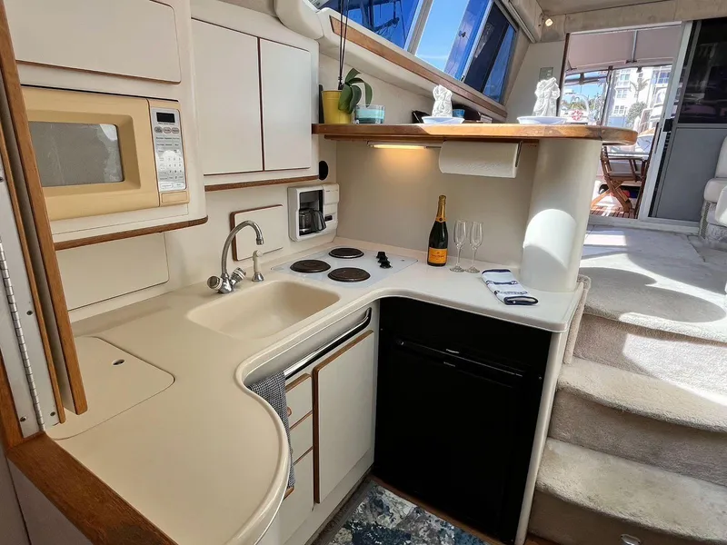 Slide: The Image of 1996 Sea Ray 370 Sedan Bridge yacht kitchen with modern amenities and elegant design. - 31