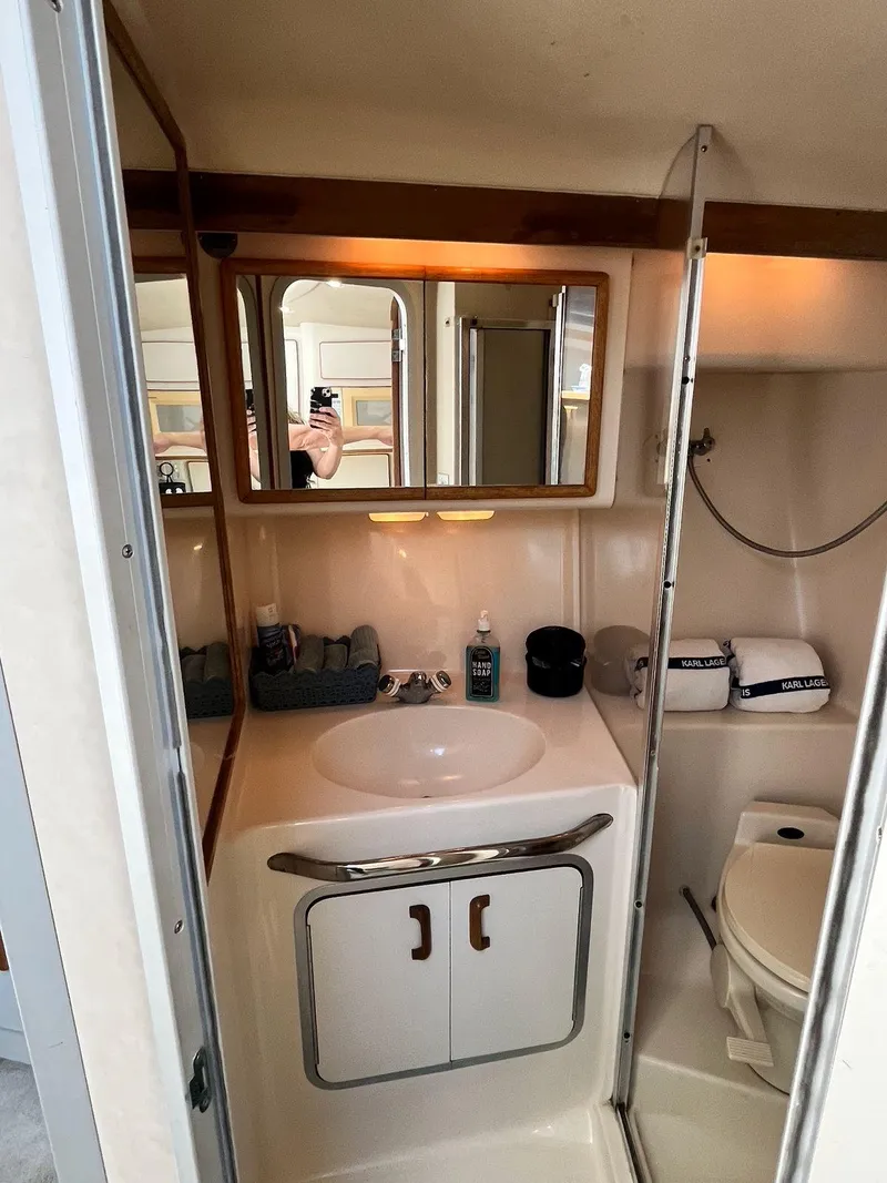 Slide: The Image of 1996 Sea Ray 370 Sedan Bridge bathroom with sink, mirror, and toilet. - 35