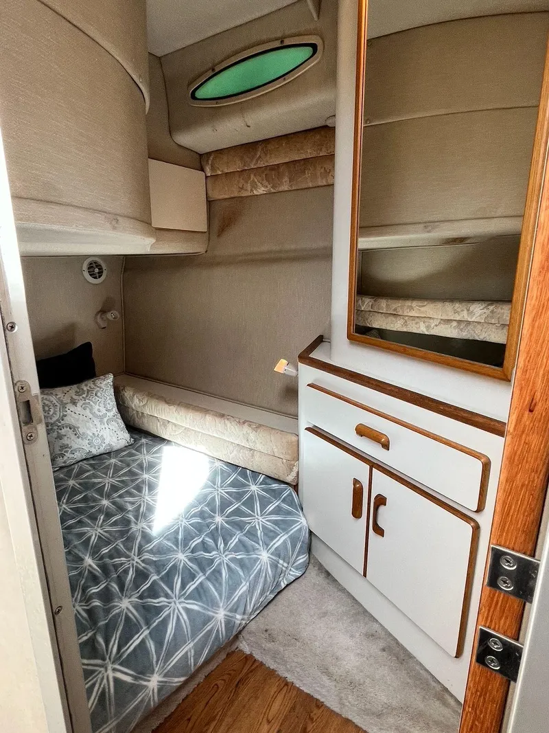 Slide: The Image of 1996 Sea Ray 370 Sedan Bridge cabin with bed, storage, and window. - 37