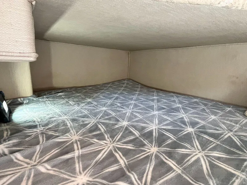 Slide: The Image of Cozy cabin interior of 1996 Sea Ray 370 Sedan Bridge with patterned bedding. - 39