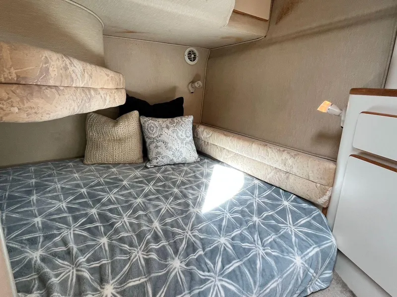 Slide: The Image of 1996 Sea Ray 370 Sedan Bridge cabin with cozy bed and decorative pillows. - 40