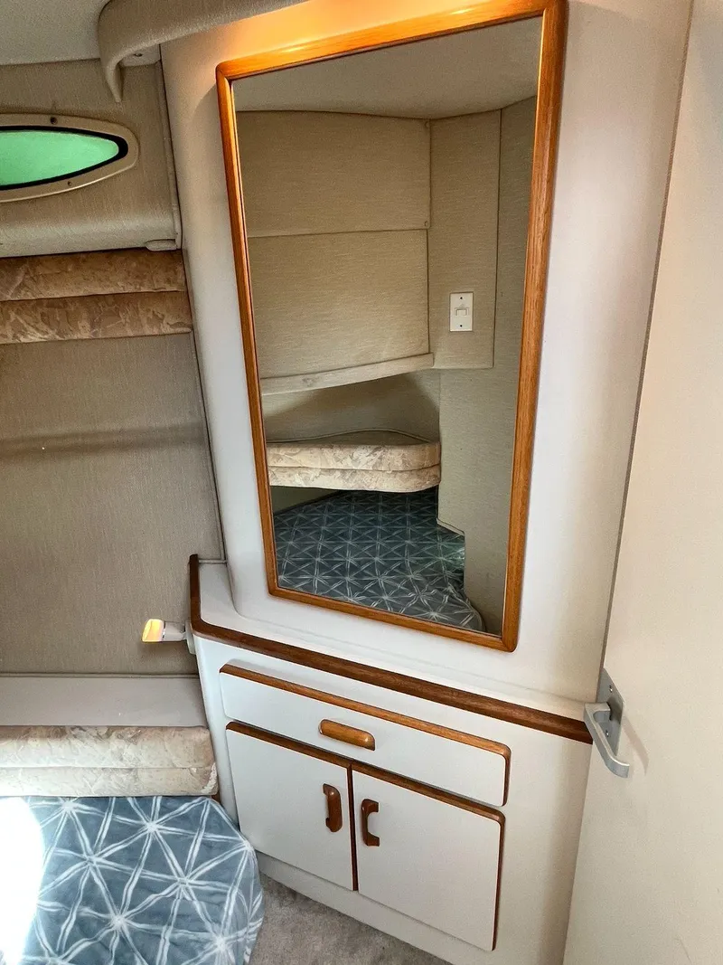 Slide: The Image of Interior of 1996 Sea Ray 370 Sedan Bridge with mirror and storage cabinet. - 41