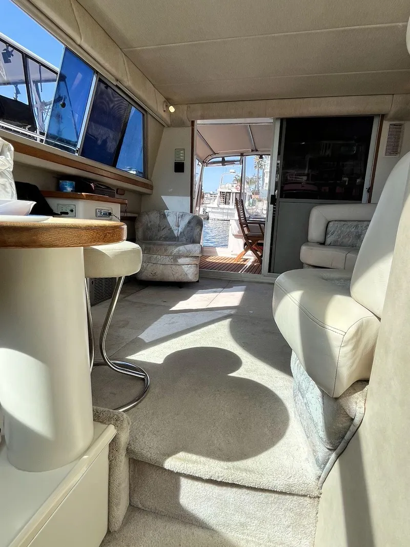 Slide: The Image of Interior of 1996 Sea Ray 370 Sedan Bridge, featuring plush seating and natural light. - 42