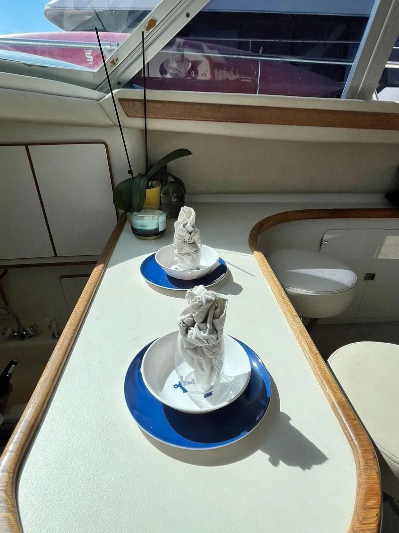 Slide: The Image of Interior of 1996 Sea Ray 370 Sedan Bridge with elegant table setting. - 43