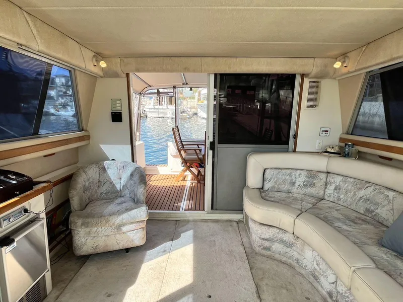 Slide: The Image of Interior of 1996 Sea Ray 370 Sedan Bridge with plush seating and outdoor view. - 45