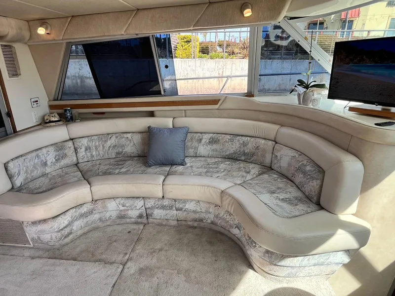 Slide: The Image of Luxurious interior of 1996 Sea Ray 370 Sedan Bridge with curved seating and modern decor. - 46