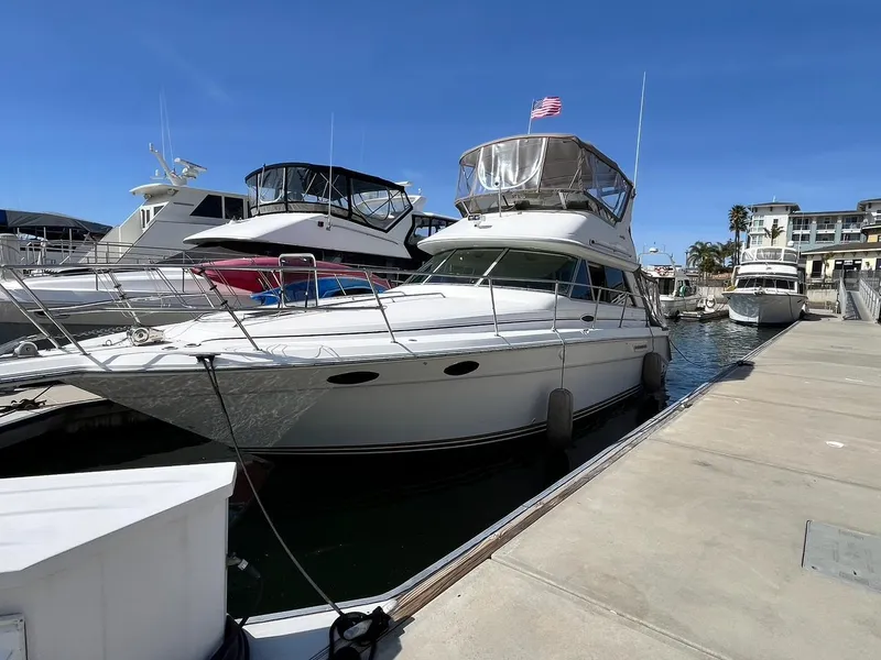 Slide: The Image of 1996 Sea Ray 370 Sedan Bridge docked at marina under clear blue sky. - 5