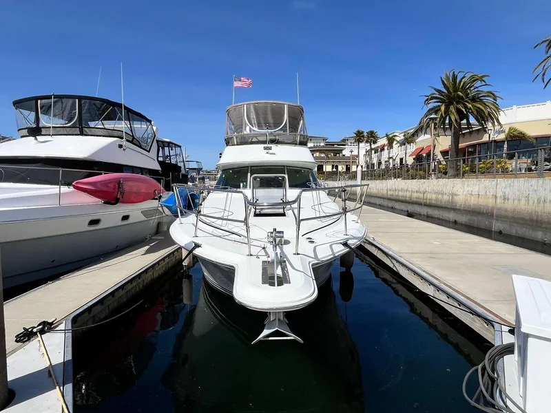 Slide: The Image of 1996 Sea Ray 370 Sedan Bridge docked at marina under clear blue sky. - 6
