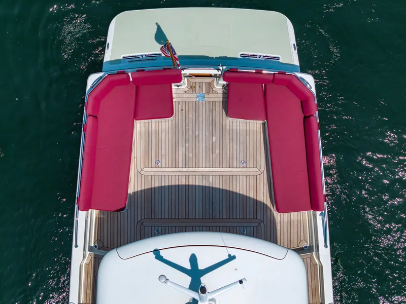 Slide: The Image of Aerial view of 2018 Back Cove Downeast 37 boat with red seating and wooden deck. - 14