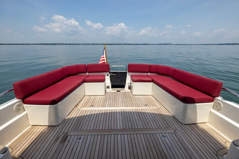 Slide: The Image of 2018 Back Cove Downeast 37 boat with red seating and wooden deck on calm water. - 16