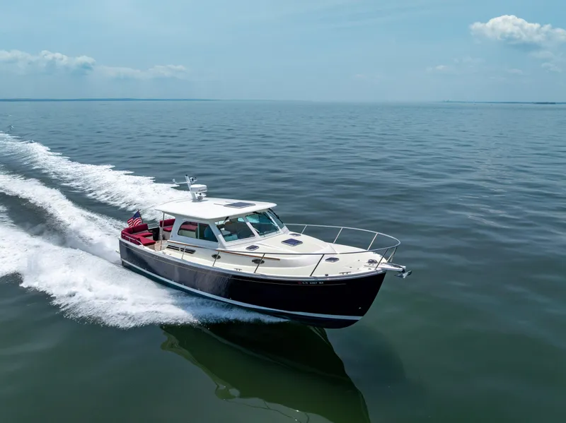 Slide: The Image of 2018 Back Cove Downeast 37 cruising on open water under clear skies. - 2