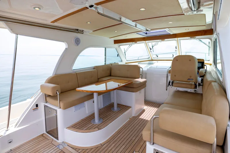 Slide: The Image of Luxurious interior of 2018 Back Cove Downeast 37 yacht with beige seating and wooden accents. - 21