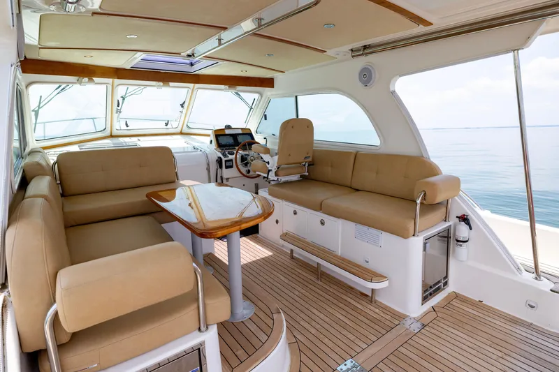 Slide: The Image of Interior of 2018 Back Cove Downeast 37 yacht with beige seating and wooden accents. - 22