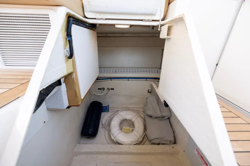 Slide: The Image of Storage compartment in 2018 Back Cove Downeast 37 boat, featuring life ring and equipment. - 24
