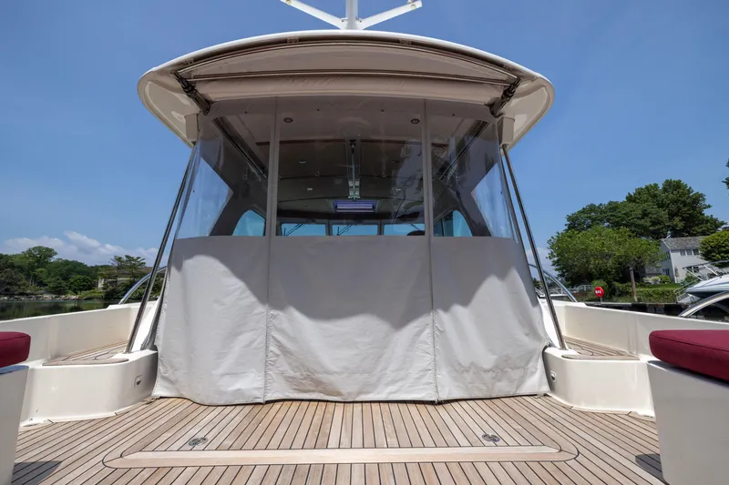 Slide: The Image of 2018 Back Cove Downeast 37 yacht with covered deck, wooden flooring, and clear skies. - 27