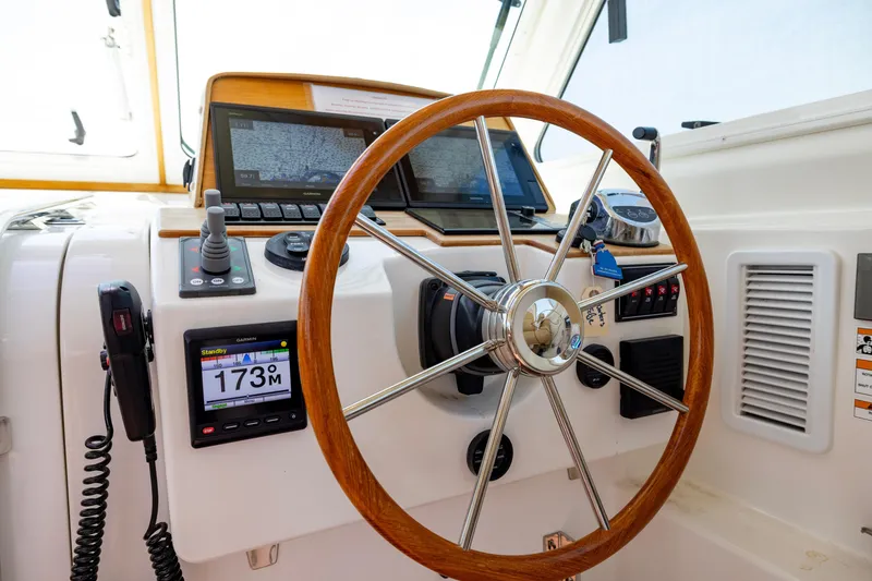 Slide: The Image of Helm of 2018 Back Cove Downeast 37 with navigation equipment and wooden steering wheel. - 28