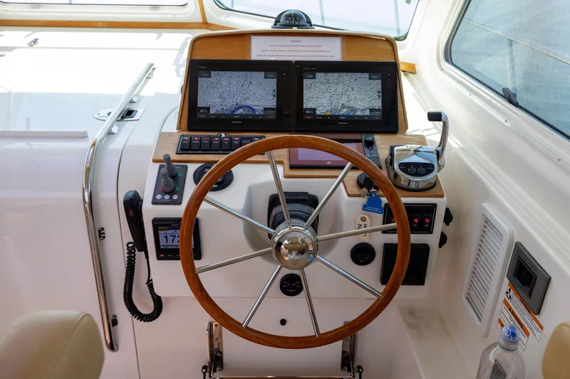 Slide: The Image of Helm of 2018 Back Cove Downeast 37 with navigation screens and wooden steering wheel. - 29